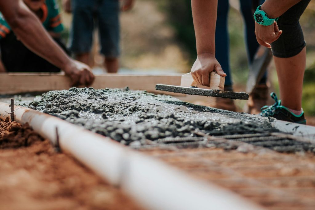 Construction workers laying concrete